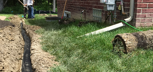 Landscapers installing yard drainage system Harrison Township MI